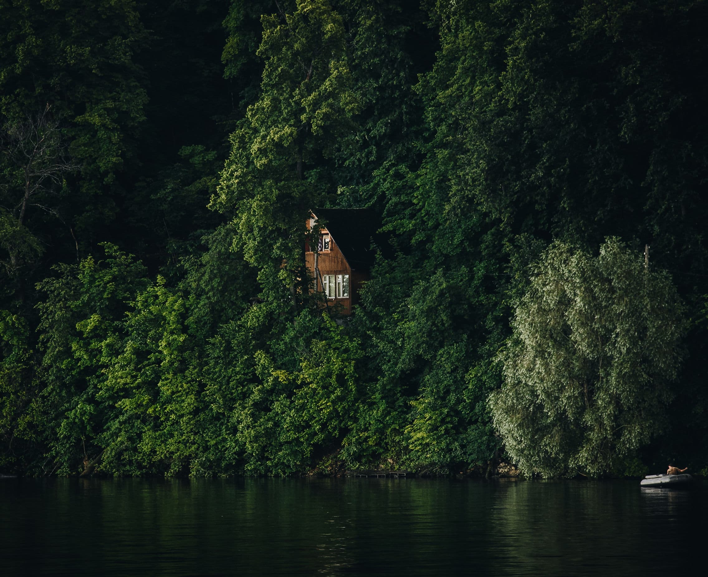 Cabin nestled in BC forest by a lake